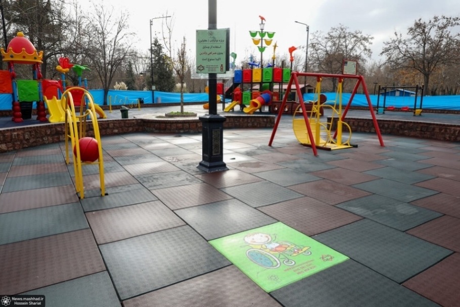 View of multiple accessible playing equipment in a park playground.