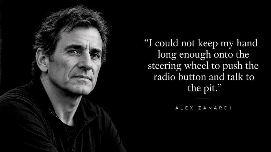 A black and white portrait of Alex Zanardi set against a solid black background, with him on the left side of the frame. He looks toward the camera with a calm, serious expression. He has thick, tousled dark hair going gray at the temples, deep lines across his forehead and around his eyes, and light stubble on his face.