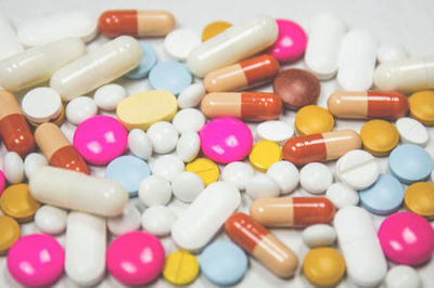Assorted multicolored prescription drug pills and capsules.