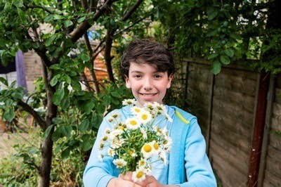 Young boy holding flowers
