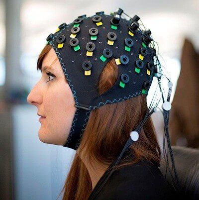 NIRS/EEG brain computer interface system shown on a model. Image Credit: Wyss Center, www.wysscenter.ch