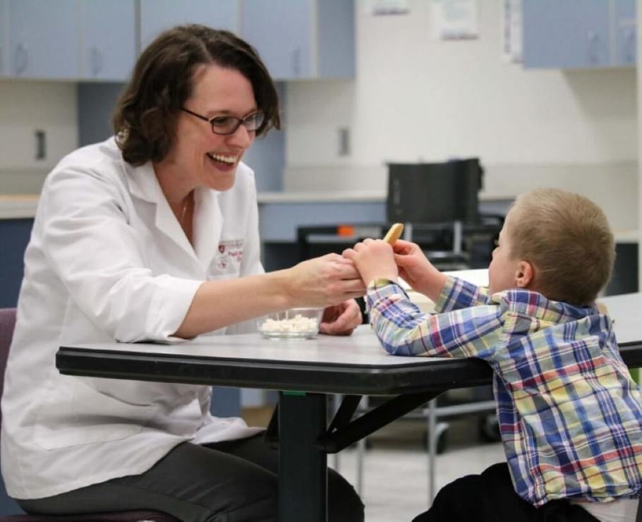 Carolyn Ross works with a child with Down syndrome on the food texture study - Photo courtesy Carolyn Ross, Washington State University.