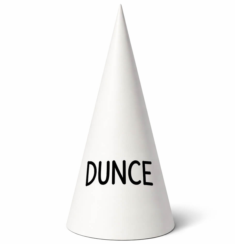 This image shows a single white dunce cap standing upright against a plain white background. The cap is cone-shaped, tapering smoothly to a rounded point at the top, with a wide circular base.