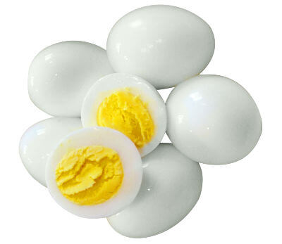 Five whole peeled hard boiled eggs with another egg cut in half on top of them.