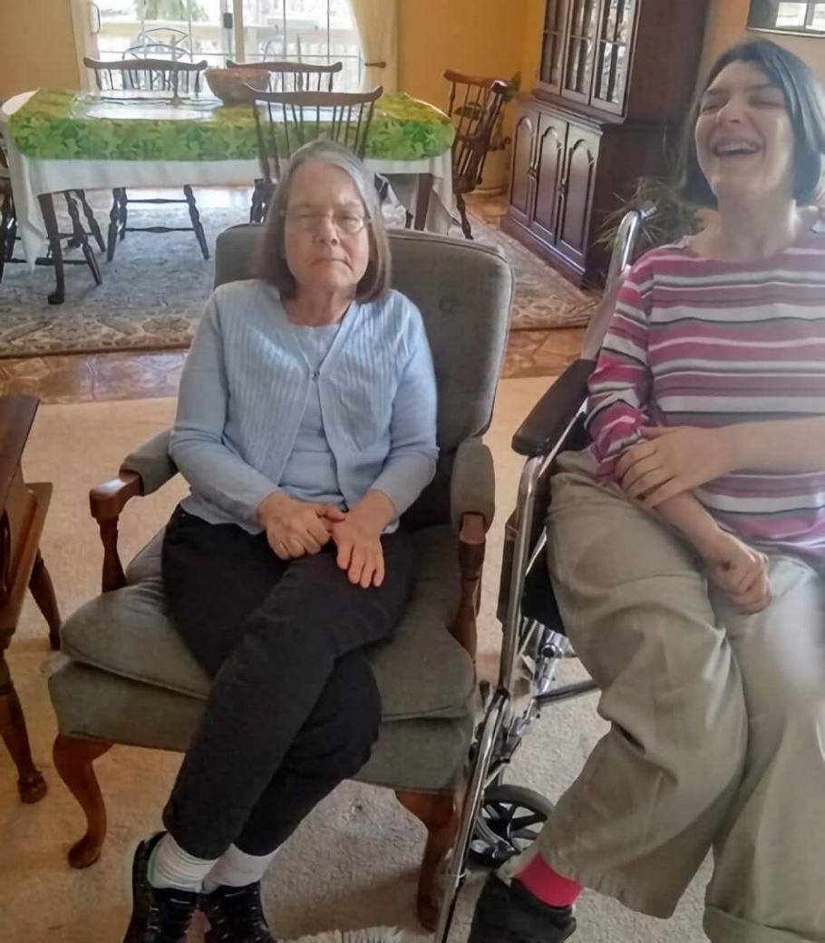 Author's sister, seated in a chair, and daughter, sitting in a wheelchair.