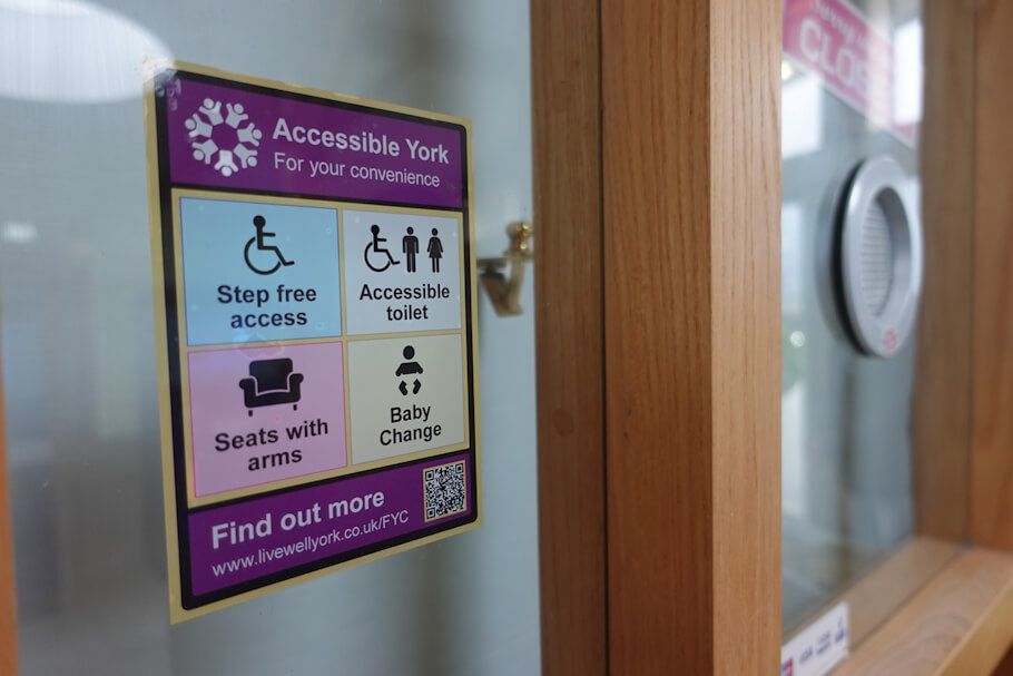 This image shows a sign on a glass door or window with the title Accessible York - For your convenience.