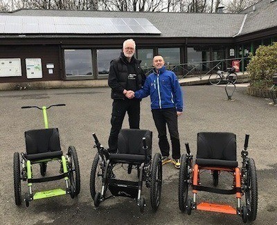 Roger Crawford hands over Mountain Trike demo models to David Hill.
