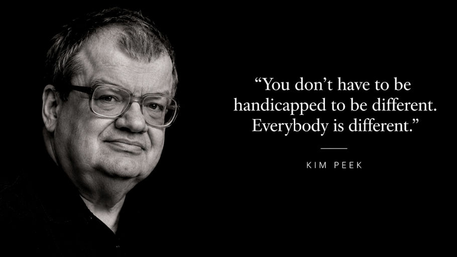 A black and white portrait of Kim Peek on a solid black background, shown from the shoulders up on the left side of the image.