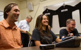 Erik Weihenmayer (L) Ashley Crandall (center) and Zachary Martinez (right) share a laugh during phone call with President George W. Bush