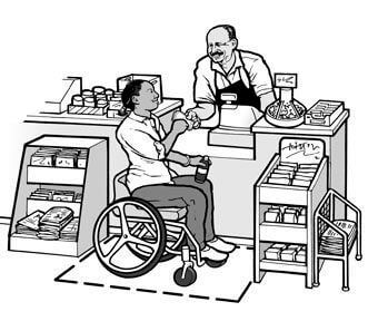 A woman using a wheelchair is buying a drink at a small grocery store. Adequate maneuvering space and a low, uncluttered counter make it possible for her to approach the sales counter.