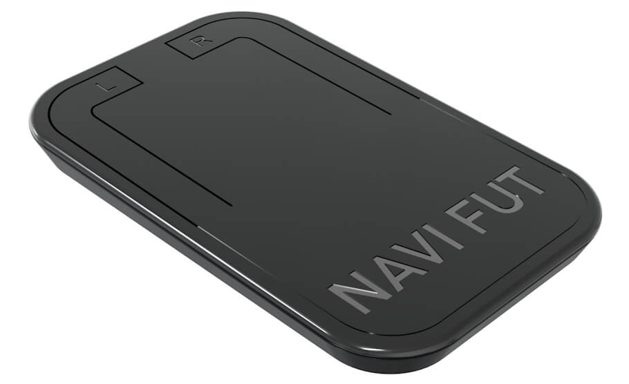 This image shows an angled, three-quarter view of a slim, rectangular assistive foot-operated mouse with rounded corners and a smooth, matte dark finish.