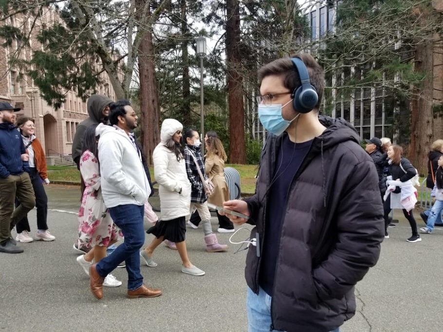 Pictured is co-author Malek Itani demonstrating the noise canceling AI headphone system - Image Credit: University of Washington.