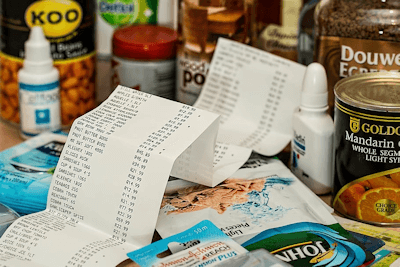 Paper receipt surrounded by grocery items.