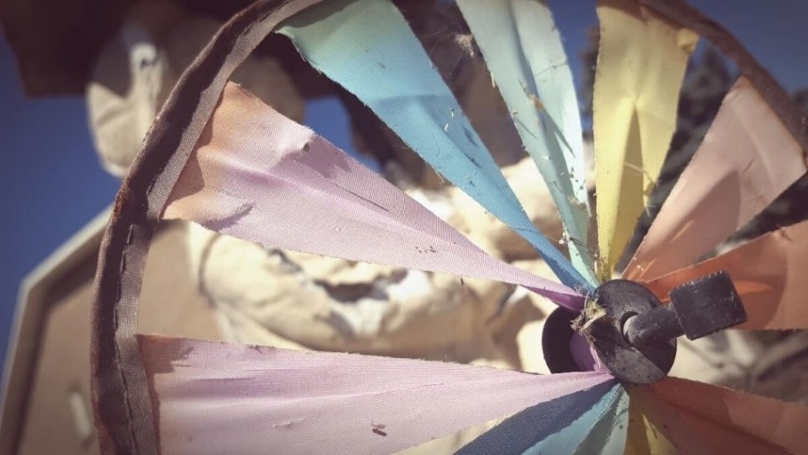 Image of an old faded tattered and torn pinwheel.