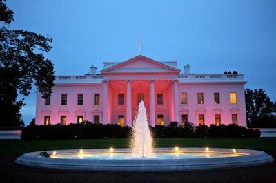 Photo shows the North Portico exterior of the United States White House illuminated with pink lights in honor of Breast Cancer Awareness Month, Oct. 1, 2012 (Official White House Photo by Sonya N. Hebert).